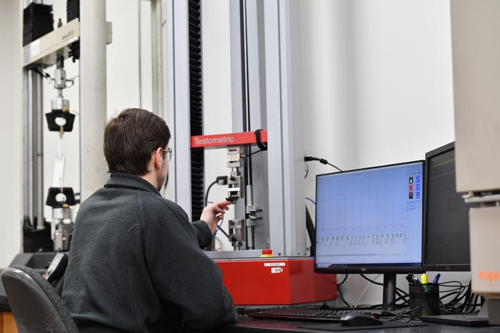 An ACE scientist runs an experiment on a Testometric machine.